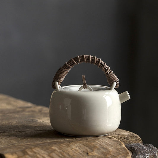 White ceramic teapot rattan woven handle teapot